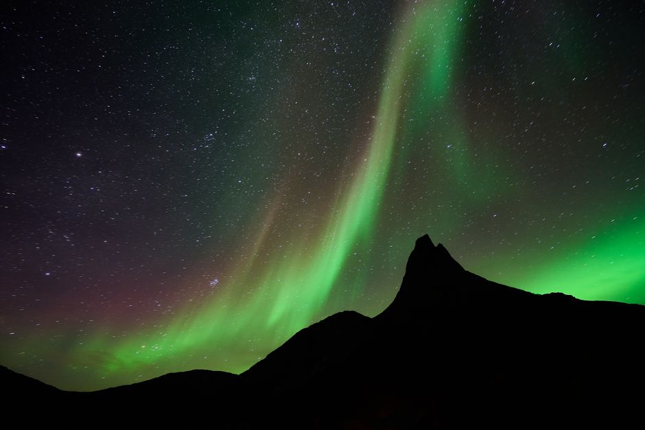 A quiet mountain landscape beneath the northern lights, reflecting the journal’s sense of everyday wonder.